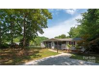 Charming single story home with a screened in porch and mature shade trees at 6271 Sherwood Ln, Denver, NC 28037