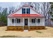 Inviting home featuring a red roof, white siding, and charming front porch at 801 Sandifer Rd, York, SC 29745