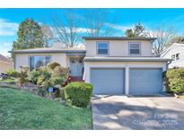 Charming two-story home featuring a well-manicured front yard and an attached two-car garage at 8210 Mattingridge Dr, Charlotte, NC 28270