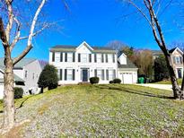 Inviting two-story home featuring classic white siding and black shutters on a well-manicured lawn at 9146 Austin Ridge Ln, Charlotte, NC 28214