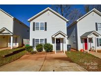 Charming two-story home featuring a symmetrical facade, tidy landscaping, and inviting curb appeal at 1008 Beaugard Dr, Charlotte, NC 28208