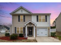 Charming two-story home featuring a well-maintained front yard and an attached garage at 1301 Waylon Ave, Gastonia, NC 28054