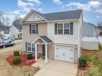 Charming two-story home features a front-facing garage, well-maintained lawn and a welcoming entrance at 1301 Waylon Ave, Gastonia, NC 28054