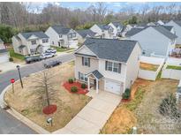 Charming two-story home with manicured lawn, freshly mulched beds, and a paved driveway at 1301 Waylon Ave, Gastonia, NC 28054