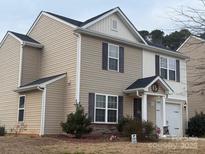 Two story home with neutral siding, stone accents, dark shutters, and a one car garage at 1301 Waylon Ave, Gastonia, NC 28054