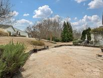 Expansive backyard patio featuring a dining area and ample space for outdoor entertaining at 14309 Stonewater Ct, Fort Mill, SC 29707