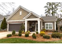 Charming single-story home with beautiful landscaping and a welcoming front porch at 16116 Lakeside Loop Ln, Cornelius, NC 28031