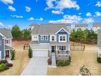 Beautiful two-story home with manicured lawn, covered front porch, and attached two-car garage at 1660 Sassafras Ct, Fort Mill, SC 29715