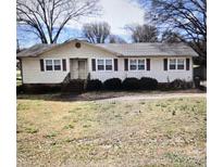 A cozy single story home featuring a well-maintained lawn, trimmed shrubs, and an inviting exterior at 1806 Little Rock Rd, Charlotte, NC 28214