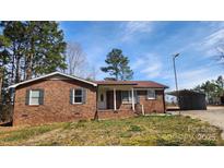 Charming single-story brick home with a cozy front porch and manicured lawn at 3272 Hunter Ridge Rd, Rock Hill, SC 29732