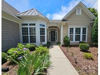 Charming single-story home with landscaped front yard and inviting entrance featuring large windows at 36112 Watsonia St, Fort Mill, SC 29707