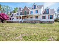 Spacious two-story home with stone accents, white siding, red shutters and a welcoming front porch at 4907 White Oak Ln, Denver, NC 28037
