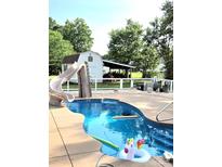 Backyard pool featuring a slide, refreshing water, and a cute unicorn floatie at 4907 White Oak Ln, Denver, NC 28037