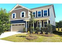 Charming two-story home with a well-manicured lawn, inviting curb appeal, and attached two-car garage at 9843 Quercus Ln, Huntersville, NC 28078