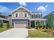 Charming two-story home featuring a two-car garage, manicured lawn, and beautiful curb appeal at 9843 Quercus Ln, Huntersville, NC 28078