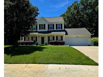 Charming two-story home with black shutters, manicured lawn, and attached two car garage at 14922 Rolling Sky Dr, Charlotte, NC 28273