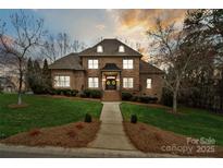 Gorgeous brick home with manicured lawn and inviting entryway at sunset at 1838 Landry Ln, Rock Hill, SC 29732