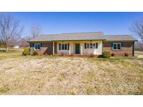 Charming ranch home featuring a brick and vinyl exterior with lush landscaping at 19 Harolds Ct, Taylorsville, NC 28681