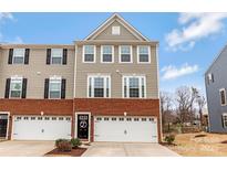 Charming three-story townhome features a brick facade, two-car garage, and inviting front entrance at 2175 Autumn Cyprus Ave, Gastonia, NC 28054