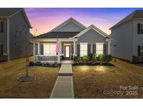 Charming single-story home with a welcoming front porch and well-maintained landscaping at 250 Kerri Dawn Ln, Locust, NC 28097