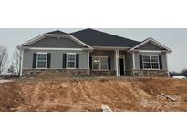 Charming single-story home with stone accents and black shutters offers modern curb appeal at 2913-B Noritake Trl, Albemarle, NC 28001