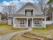 Charming two-story home with a welcoming front porch and second story balcony at 3253 Ian Patrick Ave, Kannapolis, NC 28083