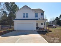 Charming two-story home boasts a two-car garage and inviting front porch at 345 Corinth Church Rd, Mooresville, NC 28115