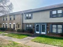 Townhome exterior showcases well-maintained landscaping, brick facade, and inviting front doors at 4520 Central Ave # C, Charlotte, NC 28205