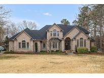 Stunning brick home featuring manicured landscaping, arched entryway, and a classic design at 507 Saint Johns Dr, Salisbury, NC 28144