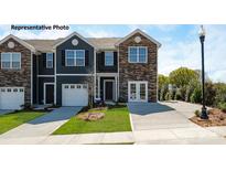 Charming townhome with stone accents, a manicured lawn, and private driveway at 531 Trading Post Ln, York, SC 29745