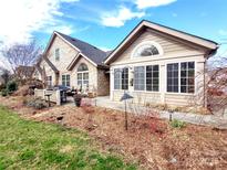 Inviting patio area perfect for outdoor dining, surrounded by lush landscaping and mature trees at 810 Wynnshire Dr # D, Hickory, NC 28601