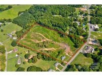 This aerial view showcases a large lot, framed by lush trees and bordered by a quiet road at 1414 S Post Rd, Shelby, NC 28152