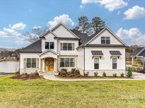 Stunning two-story home with stone accents, a manicured lawn, and charming curb appeal at 144 Morgan Bluff Rd, Mooresville, NC 28117