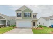 Charming two-story home featuring a two-car garage and manicured front lawn at 1620 Troon Dr, Salisbury, NC 28144