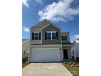 Charming two-story home with a two-car garage, neutral siding, and dark shutters under a bright blue sky at 1620 Troon Dr, Salisbury, NC 28144