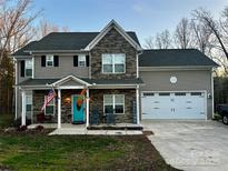 Charming two-story home with stone accents, inviting front porch, and two-car garage at 2375 Ellison Cir, Lancaster, SC 29720