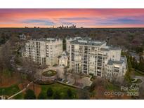 Stunning aerial view of the luxury apartment buildings with manicured landscaping and a beautiful sunset at 2823 Providence Rd # 156, Charlotte, NC 28211