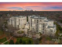 Beautiful high-rise condo complex with balconies and city views at sunset at 2823 Providence Rd # 156, Charlotte, NC 28211