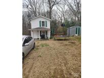 View of the home's exterior showing the front yard, white siding and landscaping at 348 Grice St, Shelby, NC 28150