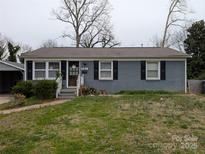 Charming single-story home with a brick facade, well-kept lawn, and inviting front entrance at 4408 Pebblebrook Dr, Charlotte, NC 28208