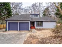 Charming single-story home featuring a two-car garage, blue trim, and well-maintained landscaping at 6415 Santa Cruz Trl # 11, Charlotte, NC 28227