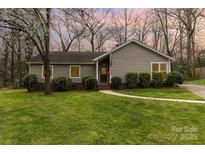 Charming single-story home with a well-manicured lawn and tidy landscaping at 7305 Park Vista Cir, Charlotte, NC 28226