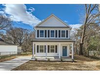 Charming two-story home with a welcoming front porch and a vibrant blue front door at 117 Mountain View St, Gastonia, NC 28052
