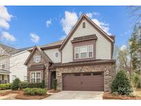 Charming two-story home boasts stone accents, a two-car garage, and a well-manicured front yard at 13725 Laughing Gull Dr, Charlotte, NC 28278