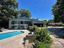 Stunning home exterior with a private pool surrounded by lush greenery and ample patio space at 18 Pickett Ave, Spencer, NC 28159