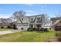 Charming two-story home featuring a three-car garage and inviting front porch at 20601 Island Forest Dr, Cornelius, NC 28031