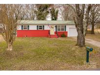 Charming single-story home with red brick foundation, yellow door, and well-maintained lawn at 2577 Kingston St, Newton, NC 28658