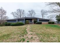Charming single-story home with a well-manicured front yard and mature landscaping at 404 Downing Dr, Kings Mountain, NC 28086