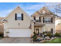 Inviting two-story home showcasing a well-kept lawn and a welcoming front entrance at 417 Galesburg Dr, Monroe, NC 28110