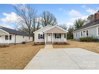 Charming single-story home featuring neutral siding, a welcoming front porch, and a well-manicured lawn at 419 N Caldwell St # 1, Salisbury, NC 28144